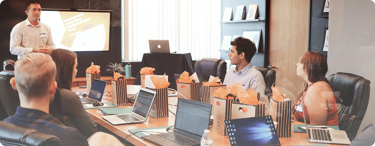 Novatore team in a meeting while a colleague presents